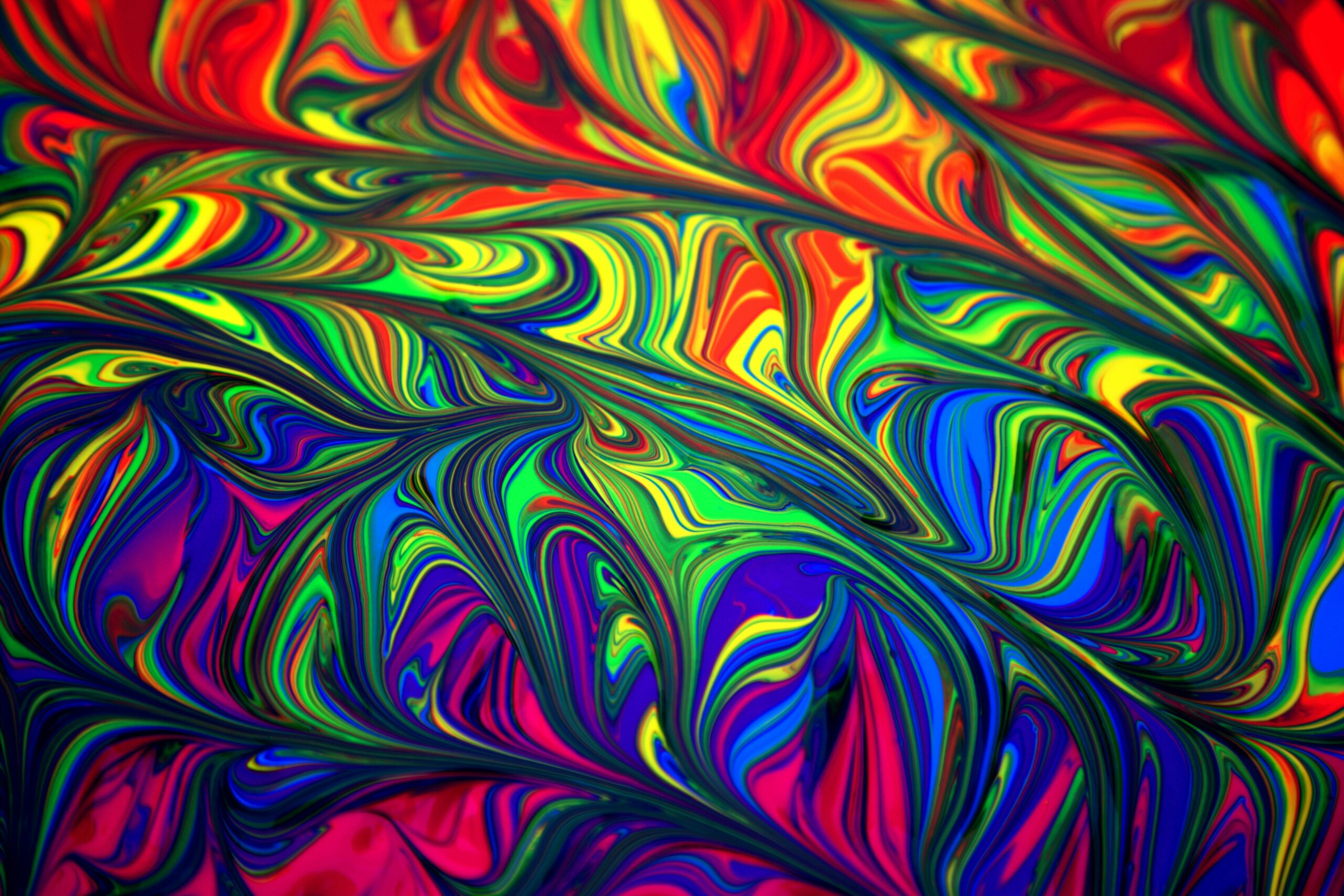 Colorful abstract swirl pattern with vibrant rainbow hues creating a dynamic and artistic background.